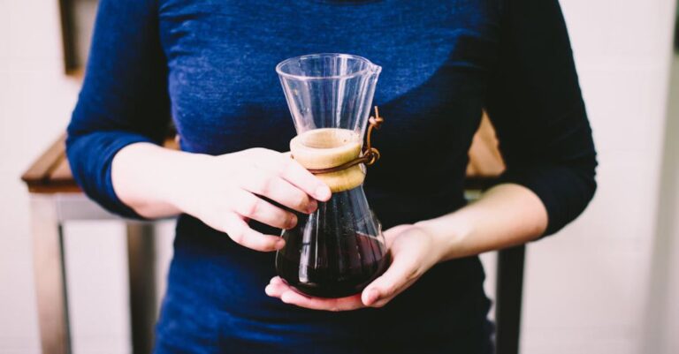 Cafes - Person Holding Clear Glass Vase