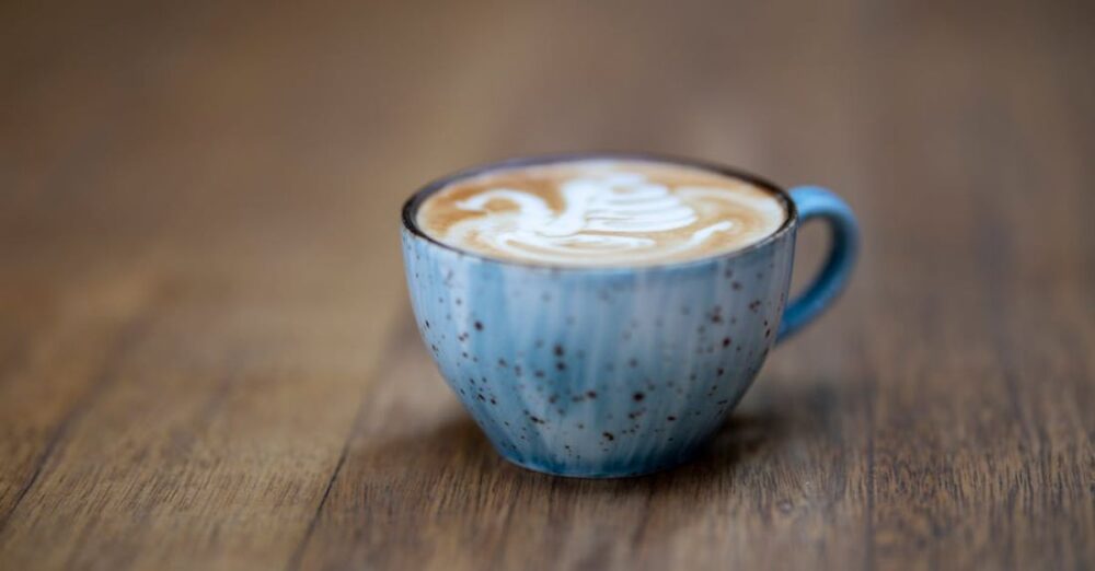 Cafes - Blue Ceramic Coffee Cup on Brown Wooden Surface