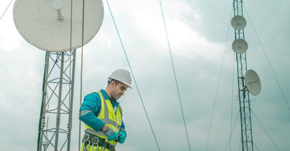 Installations - Worker Walking near Satellites