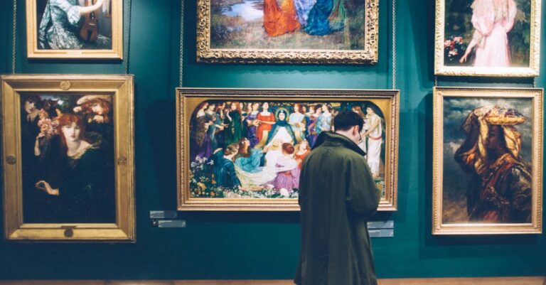 Museums - Man Standing in Front of Paintings