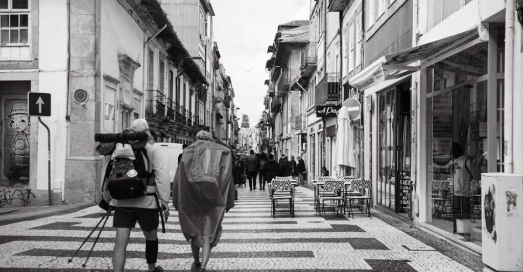 Cafes - A black and white photo of two people walking down a street