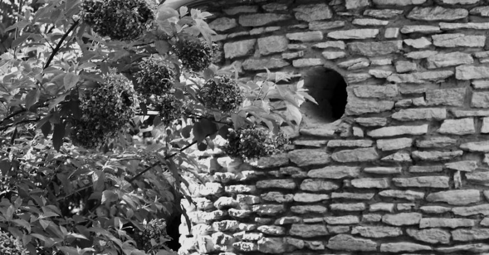 Hideaways - A black and white photo of a stone building