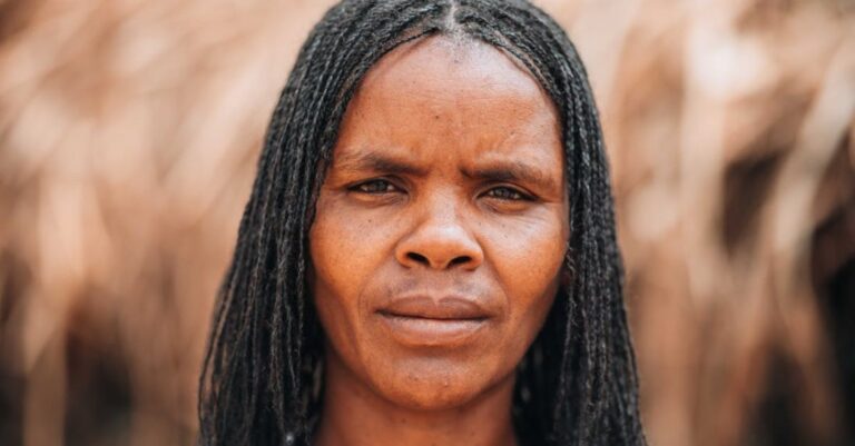 Villages - A woman with dreadlocks in front of a field