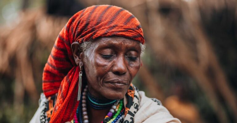 Villages - An african woman with a red headband and a red scarf