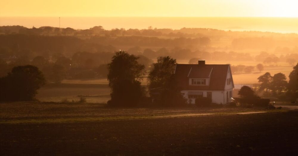 Villages - A farmhouse in the distance at sunset